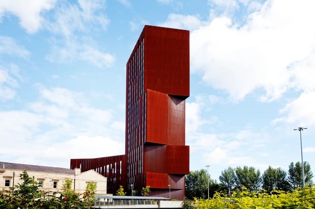 Modern red building exterior against sky exterior at Broadcasting Tower in Leeds Student Accommodation