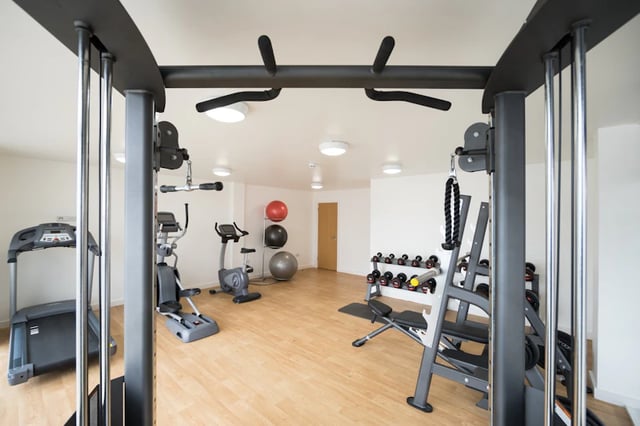Gym with treadmill elliptical bikes weights gym playing area at The Pavilion - Leeds in Leeds Student Accommodation