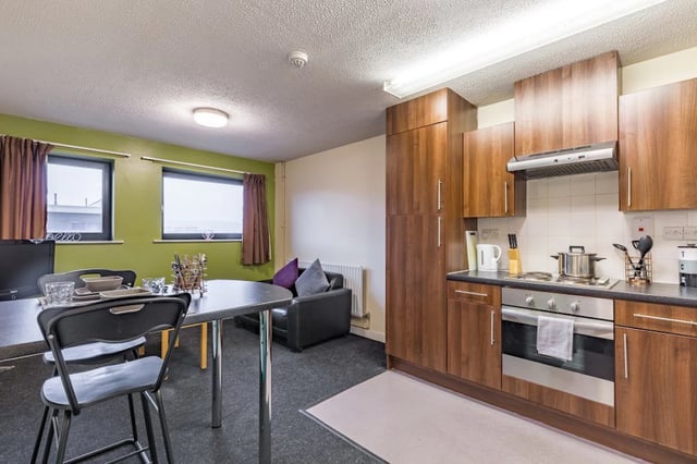 Table chairs sofa kitchen cabinets oven hob kitchen at The Pinnacles in Sheffield Student Accommodation