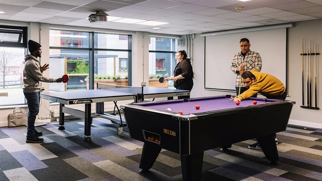 Ping pong table pool table people playing recreation room at The Pinnacles in Sheffield Student Accommodation