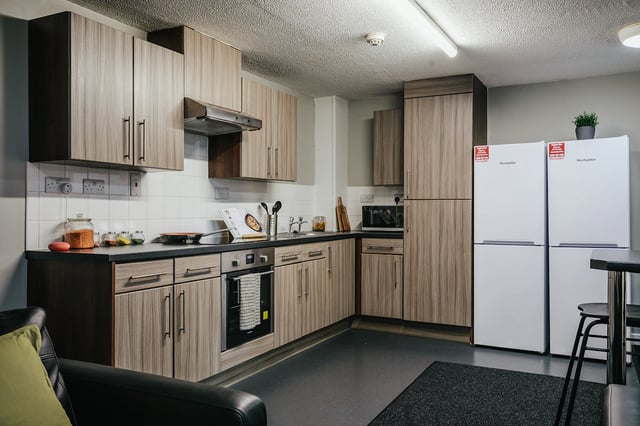 Modern kitchen with wooden cabinets two fridges oven kitchen at The Pinnacles in Sheffield Student Accommodation