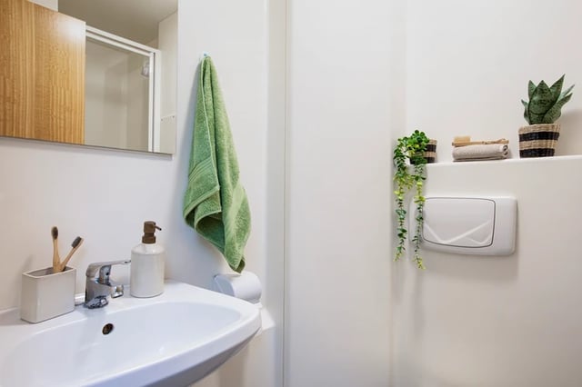Sink toothbrush holder soap dispenser towel toilet bathroom at Somerset Court in London Student Accommodation