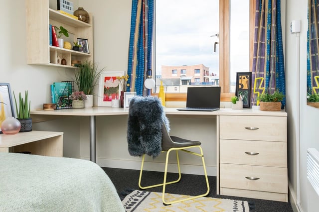 Desk with laptop plants and furry chair bedroom at Somerset Court in London Student Accommodation