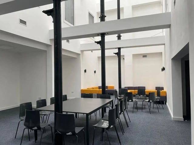 Tables chairs and sofas communal area living room at Silk Mill Lancaster in Lancaster Student Accommodation