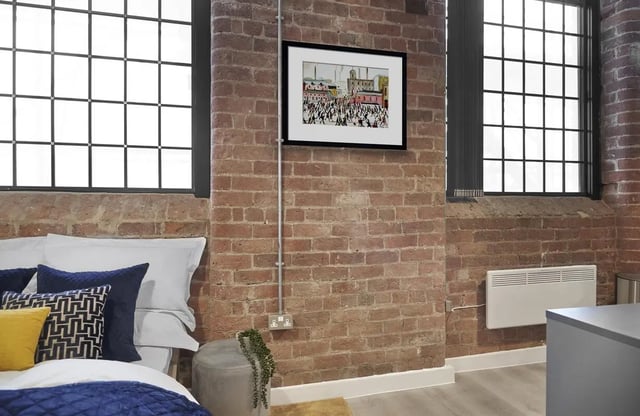 Bed pillows artwork and large windows bedroom at Silk Mill Lancaster in Lancaster Student Accommodation