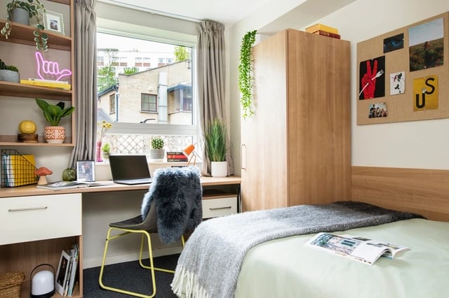 Bed desk shelving unit with laptop and wardrobe bedroom at Elizabeth Croll House in London Student Accommodation