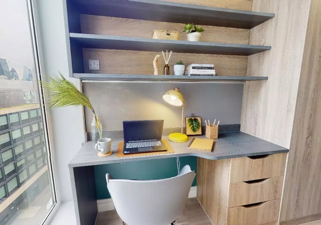 Desk with laptop lamp and chair study area at iQ Bankside in London Student Accommodation