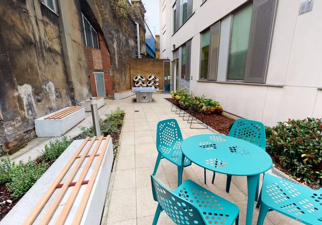 Outdoor seating and ping pong table courtyard exterior at iQ Bankside in London Student Accommodation