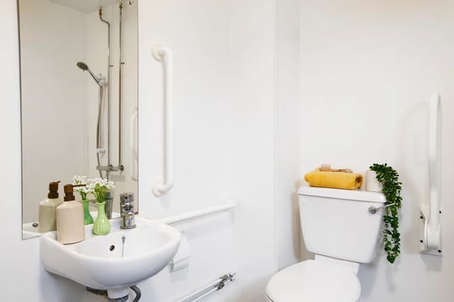 Sink shower toilet grab bars towel bathroom at East Central House in London Student Accommodation