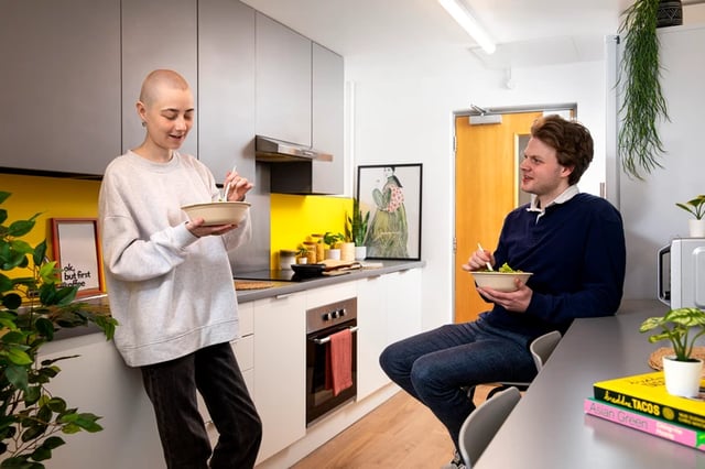 People eating salad at kitchen counter kitchen at East Central House in London Student Accommodation