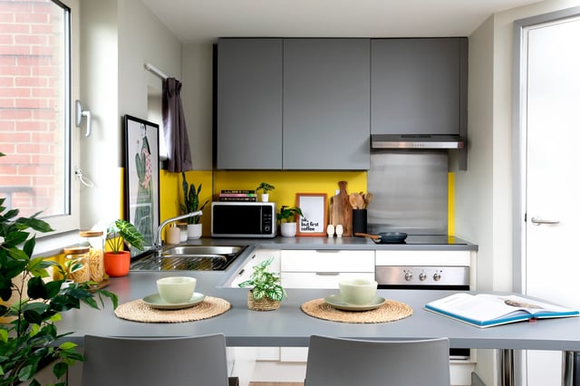 Modern student kitchen with microwave and place settings kitchen at East Central House in London Student Accommodation
