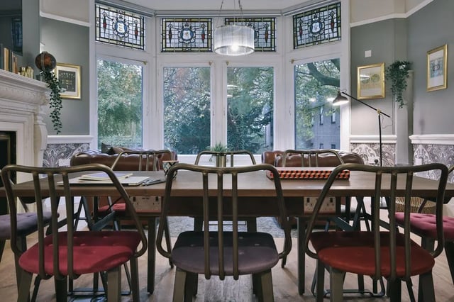 Dining table with chairs and leather sofas living room at Claremont Place in Newcastle Upon Tyne Student Accommodation