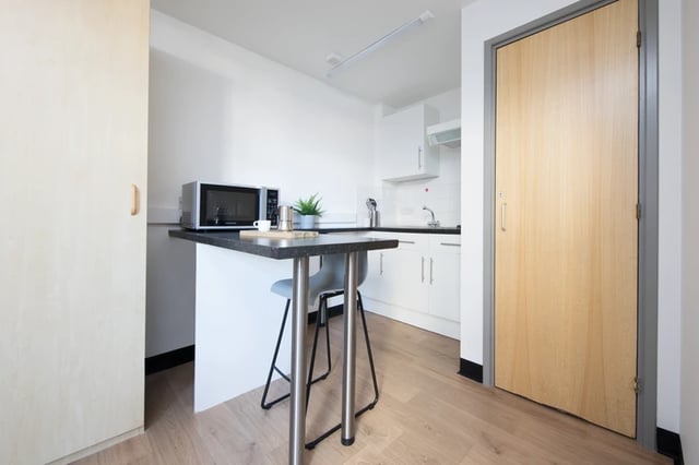 Countertop microwave table and chair kitchen at Magnet Court in Newcastle Upon Tyne Student Accommodation