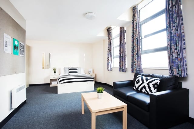 Bed sofa table and heater bedroom at Magnet Court in Newcastle Upon Tyne Student Accommodation