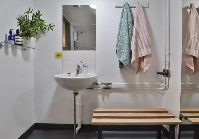 Sink plant mirror towels bench bathroom at iQ Stephenson House in Newcastle Upon Tyne Student Accommodation
