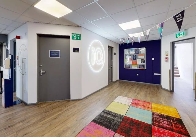 Entrance hall with colorful rug and noticeboard hallway at iQ Stephenson House in Newcastle Upon Tyne Student Accommodation
