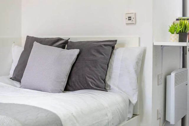 Bed with pillows and heater bedroom at Glassworks - Liverpool in Liverpool Student Accommodation