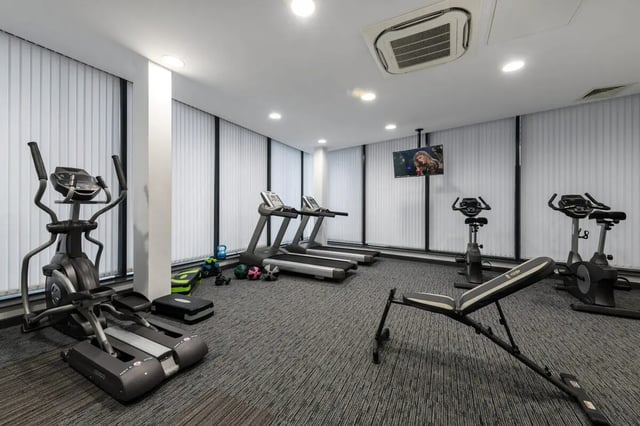 Gym with treadmills bikes bench weights tv. at Glassworks - Liverpool in Liverpool Student Accommodation