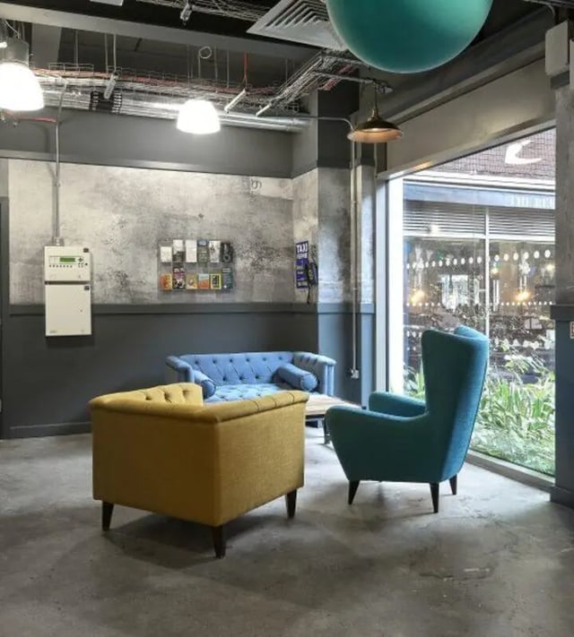 Blue and yellow couches and chair living area at Hope Street in Liverpool Student Accommodation