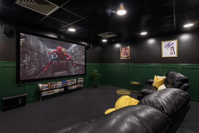 Leather sofas projector screen movie posters entertainment room at Hope Street in Liverpool Student Accommodation