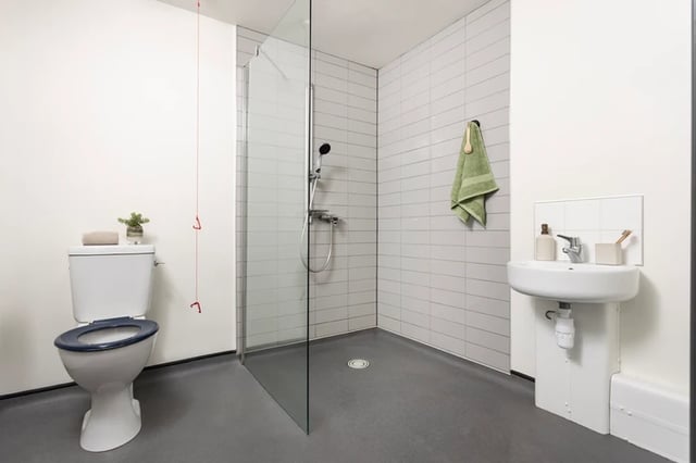 Toilet shower sink with green towel Bathroom at Leadmill Point in Sheffield Student Accommodation