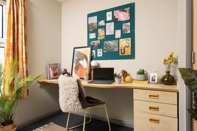 Desk with laptop chair plants and artwork study area at Leadmill Point in Sheffield Student Accommodation