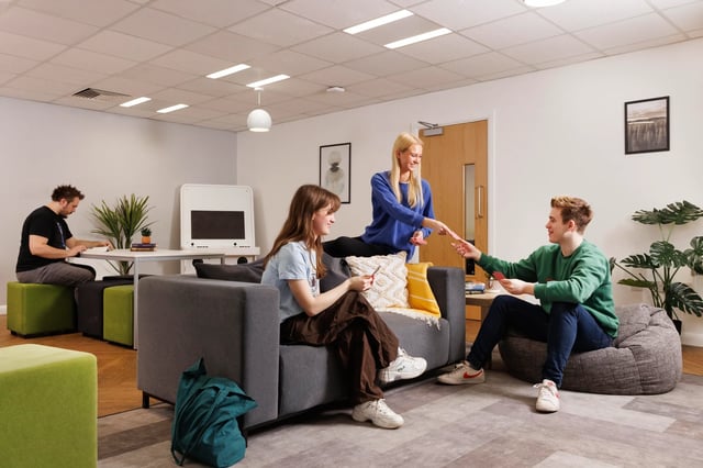 Students playing cards in lounge living room at Leadmill Point in Sheffield Student Accommodation