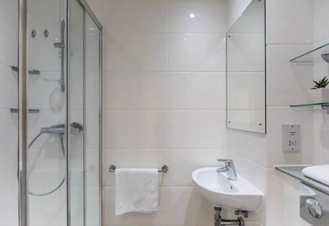 Shower sink mirror towel bathroom at Aparto Arbury Court in Kingston Upon Thames Student Accommodation