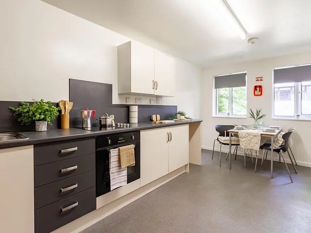 Modern student kitchen with table and chairs kitchen at Yugo Park Court in Lincoln Student Accommodation