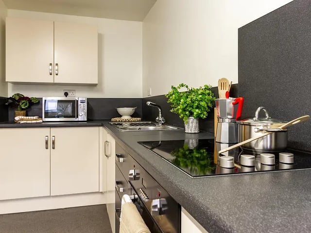 Microwave sink pots and cabinets kitchen at Yugo Park Court in Lincoln Student Accommodation