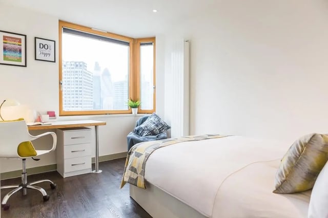 Desk chair framed pictures bed and window bedroom at Chapter Aldgate in London Student Accommodation