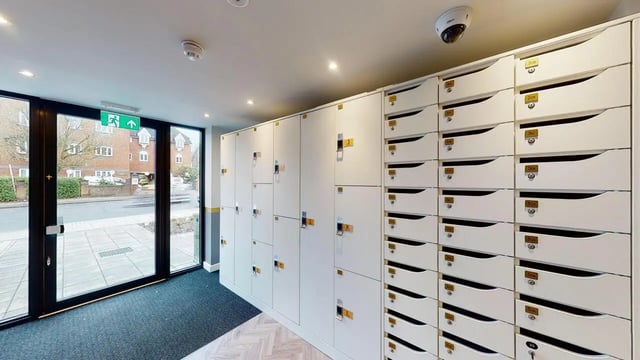 White mailboxes and lockers with numbered slots exterior at Astra House in London Student Accommodation
