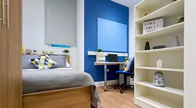 Bed desk chair bookshelf bedroom at St Leonard's House in Lancaster Student Accommodation