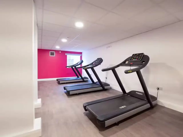 Three treadmills in a gym facility. at St Leonard's House in Lancaster Student Accommodation