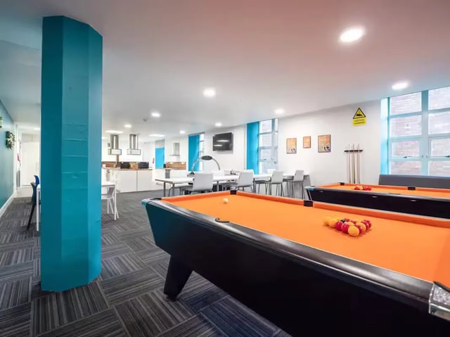 Billiard tables with balls and cues game area at St Leonard's House in Lancaster Student Accommodation