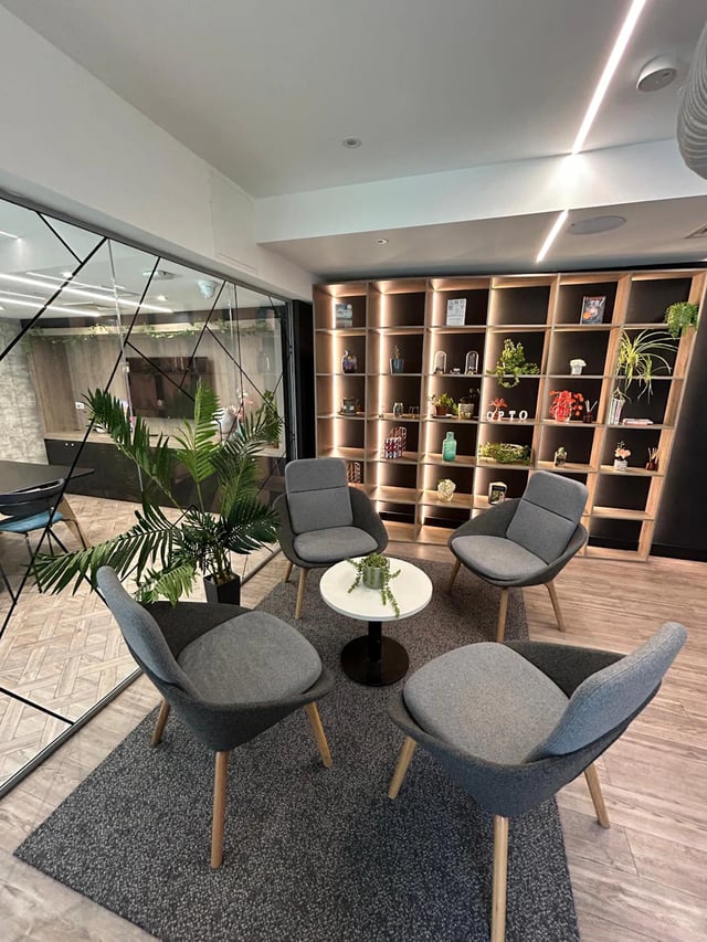 Four grey chairs surrounding small coffee table living room at Opto Newcastle in Newcastle Upon Tyne Student Accommodation