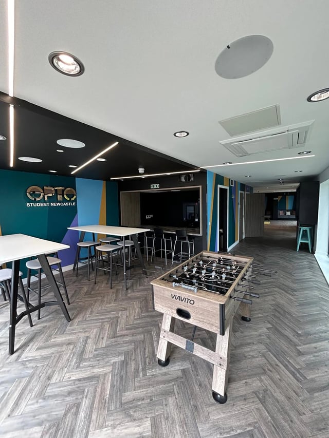 Foosball table tables and stools communal area at Opto Newcastle in Newcastle Upon Tyne Student Accommodation