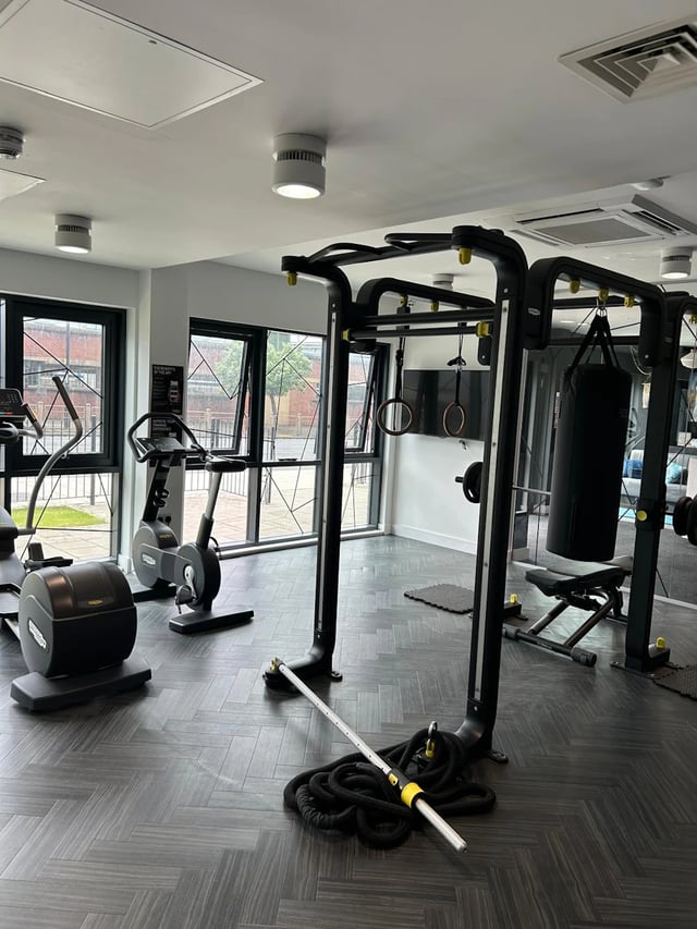 Gym equipment including exercise bikes and punching bag Gym at Opto Newcastle in Newcastle Upon Tyne Student Accommodation