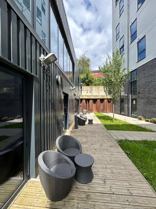 Wicker chairs and table on deck outdoor area at Opto Newcastle in Newcastle Upon Tyne Student Accommodation