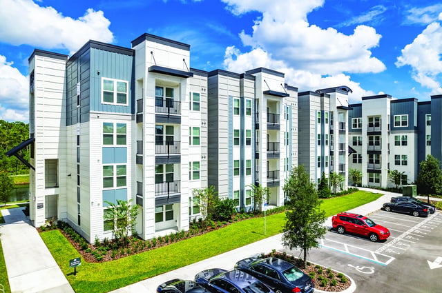 Apartment building with balconies cars and parking exterior at Vale East in Orlando Student Accommodation