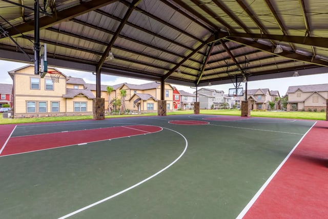 Covered outdoor basketball court with residential buildings exterior at The Retreat West in Orlando Student Accommodation