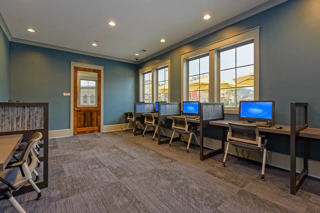 Computers and chairs in a study area at The Retreat West in Orlando Student Accommodation
