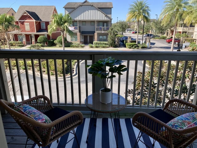 Two chairs table plant balcony view exterior at The Retreat West in Orlando Student Accommodation