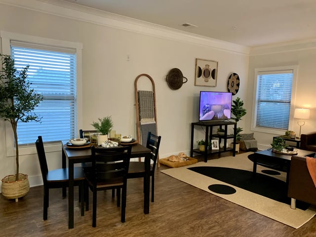 Dining table TV and dog living room at The Retreat West in Orlando Student Accommodation