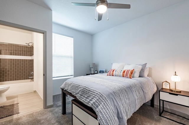 Bed with patterned bedding and nightstand Bedroom exterior at Vale East in Orlando Student Accommodation