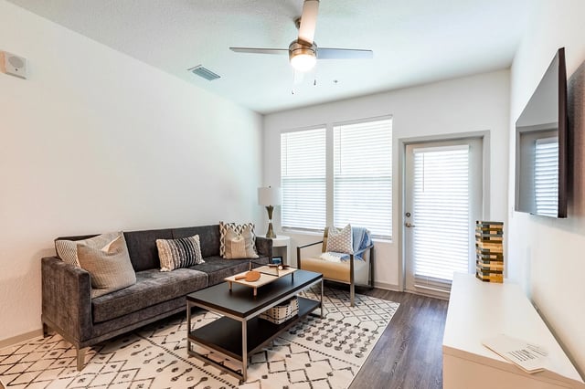 Dark grey sofa coffee table and chair living room at Vale East in Orlando Student Accommodation