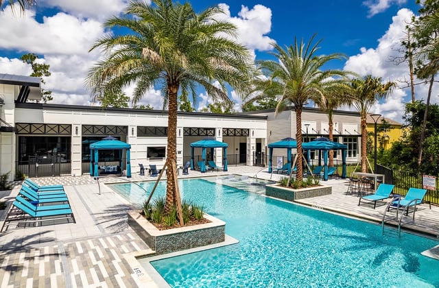 Poolside lounge chairs cabanas and building exterior area at Vale East in Orlando Student Accommodation