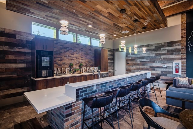 Bar with brick base white counter stools living room lounge area lounge at Vale East in Orlando Student Accommodation