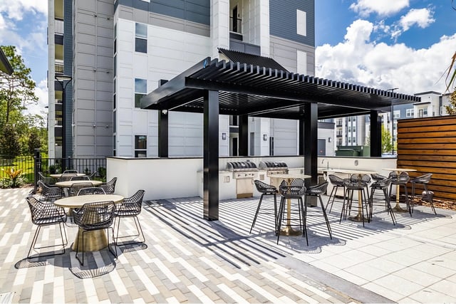 Outdoor kitchen with grills and tables exterior at Vale East in Orlando Student Accommodation