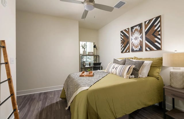 Bed with pillows and wooden tray Bedroom at The Retreat East in Orlando Student Accommodation